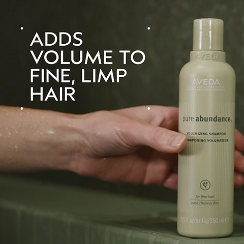 Image 2 - A hand holds a light beige Aveda shampoo bottle against a green background, with white text overlaying the image, and text on the bottle. The overlay text reads: ADDS VOLUME TO FINE, LIMP HAIR. The bottle label reads: AVEDA THE ART AND SCIENCE OF PURE FLOWER AND PLANT ESSENCES pure abundance. VOLUMIZING SHAMPOO SHAMPOOING VOLUMATEUR for fine hair pour cheveux fins 8.5 fl oz/oz liq/250 ml e. Image 3 - A dark green background with a central white circle containing abstract blurry green and blue imagery, and text that reads ACACIA GUM & KAOLIN CLAY HELPS FILL OUT FINE HAIR. Image 4 - A split image shows a woman with shoulder-length hair before and after styling; on the left, labeled BEFORE, her hair appears flatter and less defined, while on the right, labeled AFTER, her hair is significantly more voluminous and styled, with additional text stating Unwashed Hair on the bottom left and Results with Pure Abundance™ Volumizing Shampoo, Volumizing Clay Conditioner, Style-Prep™, and Volumizing Hair Spray, Phomollient™ Styling Foam. Blow dried with Mini Wooden Paddle Brush. on the bottom right. Image 5 - The image displays a four-step hair care guide titled HOW TO USE, with each step illustrated by a circular photo and accompanied by text: 01 CLEANSE shows hands massaging shampoo into wet hair with lather, for Pure Abundance™ Volumizing Shampoo; 02 CONDITION shows hands dispensing thick white conditioner from a light green bottle, for Pure Abundance™ Volumizing Conditioner; 03 STYLE shows a person brushing short hair with an orange paddle brush and visible white styling product, for Pure Abundance™ Style-Prep™ Phomollient™ Styling Foam & Mini Paddle Brush; and 04 HOLD shows a person applying hair spray from a light green bottle, for Pure Abundance™ Volumizing Hair Spray. Image 6 - A split image shows a persons short, reddish-brown hair from behind, with the left side labeled BEFORE and Unwashed Hair showing flatter hair, and the right side labeled AFTER showing the same hair with increased volume and shine, along with the text Results with Pure Abundance™ Volumizing Shampoo, Volumizing Clay Conditioner, Style-Prep™, and Volumizing Hair Spray, Phomollient™ Styling Foam. Blow dried with Mini Wooden Paddle Brush. Image 7 - A close-up shows a foamy, off-white blob of liquid with many small and large bubbles spread across a plain white background. Image 8 - The image displays three white certification logos against a background of dark green tropical leaves and a red plant stem, showing the 100% VEGAN logo, the Certified B Corporation logo, and the Cruelty Free INTERNATIONAL logo.