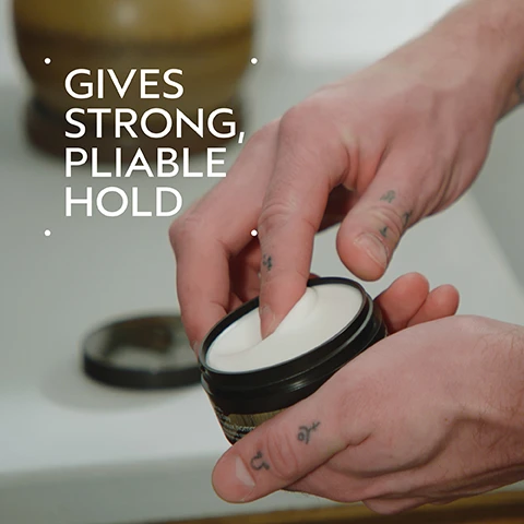 Image 2 - A persons hand dips a finger into an open black jar containing white hair styling product, with the text GIVES STRONG, PLIABLE HOLD displayed prominently. Image 3 - A side-by-side comparison of a man with dark brown hair, labeled BEFORE and AFTER. On the left, his unstyled hair falls over his forehead, with text Unwashed Hair. On the right, his hair is neatly styled and swept back, with text Results with Aveda Men Pure-Formance™ Shampoo, Conditioner, and Grooming Clay. Blow dried hair. Image 4 - A dark green background with a circular image in the center showing green plant matter submerged in clear blue water with bubbles, accompanied by the text: FORMULATED WITHOUT ANIMAL DERIVED INGREDIENTS, MINERAL OIL, SLS, SLES, SYNTHETIC FRAGRANCE, PARABENS, PHTHALATES, PETROLATUM, PARAFFIN, & FORMALDEHYDE DONORS. Image 5 - A creamy, off-white smear of lotion or moisturizer with a soft shadow is visible on a white background. Image 6 - A three-panel collage demonstrating a hair care routine, with the top panel showing hands washing hair with shampoo, the middle panel showing a hand holding an Aveda Pure-Formance conditioner bottle, and the bottom panel showing hands rubbing styling cream; the visible text reads HOW TO USE 01 CLEANSE Aveda Men Pure-Formance™ Shampoo 02 CONDITION Aveda Men Pure-Formance™ Conditioner 03 STYLE Aveda Men Pure-Formance™ Liquid Pomade and Grooming Cream, and the conditioner bottle also shows pure-formance conditioner après-shampooing for scalp and hair pour le cuir chevelu et le cheveu 10 fl oz/oz liq/300 ml e. Image 7 - Three white certification logos are displayed against a dark green leafy background with a red plant visible on the left edge, featuring text that reads 100% VEGAN, Certified B Corporation, and Cruelty Free INTERNATIONAL.