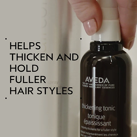 Image 2 - A hand holds a dark brown Aveda thickening tonic bottle with a white cap, featuring text on the left that reads HELPS THICKEN AND HOLD FULLER HAIR STYLES, and the bottle label displaying AVEDA THE ART AND SCIENCE OF PURE FLOWER AND PLANT ESSENCES thickening tonic tonique épaississant instantly thickens for a fuller style épaissit instantanément les cheveux pour une coiffure plus dense. Image 3 - A side-by-side comparison shows a woman with long red hair, on the left her hair is wavy and appears unwashed, and on the right her hair is smooth and styled, with the visible text BEFORE, AFTER, Unwashed Hair, and Results with Cherry Almond Softening Shampoo and Conditioner, Speed of Light Blow Dry Accelerator, Thickening Tonic, Botanical Repair™ Bond-Building Styling Crème, and Air Control Light Hold Hair Spray. Blow dried with Wooden Paddle Brush. Image 4 - A dark green background features a white circle showcasing ingredients including green wheat stalks, an amla fruit with green leaves, and a pile of colorful corn kernels, with text that reads AMLA, WHEAT, & CORN HELP THICKEN AND HOLD YOUR FULLER HAIRSTYLE. Image 5 - A four-step hair care routine is displayed with circular images for each step: step one shows hands washing hair, step two shows conditioner being dispensed into a hand, step three shows a hand spraying a hair product, and step four shows various hair styling products and a brush on a tray, with text that reads HOW TO USE, 01 CLEANSE Cherry Almond Softening Shampoo, 02 CONDITION Cherry Almond Conditioner, 03 PREP Speed of Light Blow Dry Accelerator, 04 STYLE Thickening Tonic, Botanical Repair™ Bond-Building Styling Crème, Air Control Light Hold Hair Spray & Wooden Paddle Brush. Image 6 - A single, viscous, translucent golden-yellow droplet containing small air bubbles is isolated on a white background. Image 7 - Dark green foliage in the background with three white logos: a 100% VEGAN logo with a large V in a circle, a Certified B Corporation logo with a B in a circle, and a Cruelty Free INTERNATIONAL logo with a leaping bunny.