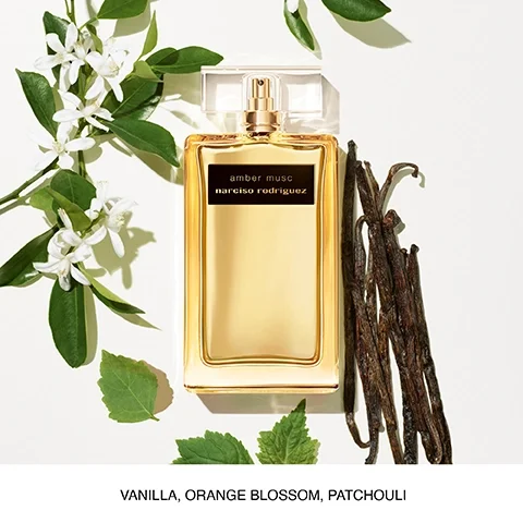 A perfume bottle labeled amber musc narciso rodriguez surrounded by white flowers, green leaves, and vanilla pods, with the text VANILLA, ORANGE BLOSSOM, PATCHOULI at the bottom.