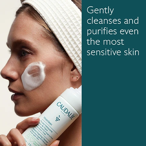 Image 1 - A woman with a headband applies a foamy cleanser to her cheek while holding a bottle of Caudalie Vinoclean; visible text reads Gently cleanses and purifies even the most sensitive skin.
Image 2 - A bottle of Caudalie Vinoclean Instant Foaming Cleanser is surrounded by green grapes, sage leaves, and flowers on a clean surface, with visible text stating Green grape hydrates, Sage purifies, and Chamomile soothes skin.
Image 3 - Image shows two skincare products side by side: a bottle of Make-up Removing Oil on the left and a pump bottle of Instant Foaming Cleanser on the right, with descriptions below each product listing their key features: Oil texture, dissolves makeup even waterproof, face and eyes for the oil and foam texture, gently cleanses and purifies, sensitive skin for the cleanser.
Image 4 - Image of a bottle of Caudalie Vinoclean Instant Foaming Cleanser with green foliage beside it, showing recycling instructions that read 1 Recycle the bottle in the recycling bin 2 Recycle the pump with Terracycle.
Image 5 - An arrangement of five skincare products by Caudalie, including Micellar Water, Make-up Removing Oil, Cleansing Milk, Instant Foaming Cleanser, and Moisturizing Toner, all labeled with their respective names.