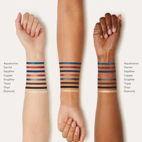 swatches on 3 different skin tones. aquamarine, garnet, sapphire, copper, graphite, topaz, onyx, diamond.