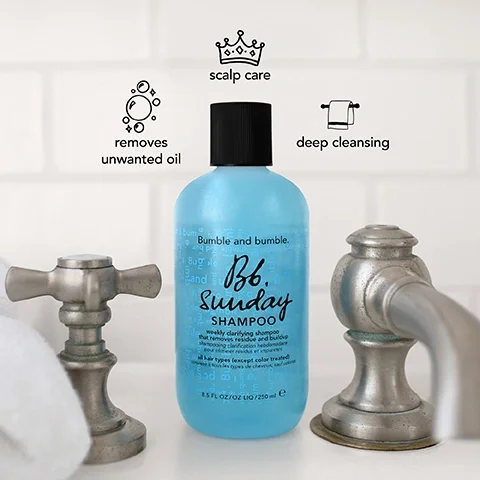 Image 1 - A bottle of Bumble and bumble Sunday Shampoo is positioned between two metallic faucets, with icons above it indicating scalp care, removal of unwanted oil, and deep cleansing; the bottle label reads Bumble and bumble 8.5 FL OZ / 250 mL Sunday Shampoo weekly clarifying shampoo that removes residue and buildup for all hair types (except color treated).