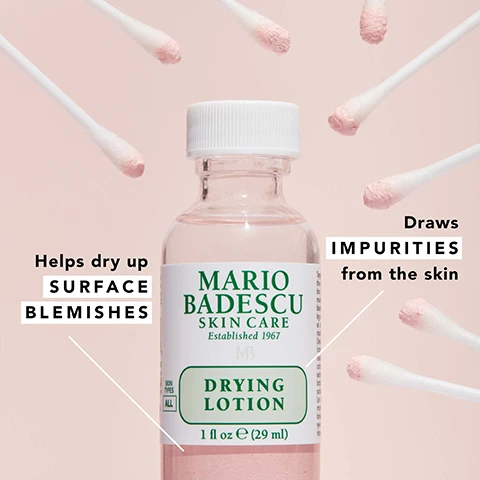 Image 1 - A bottle of Mario Badescu Drying Lotion is centered in the image, surrounded by cotton swabs; the bottle features the text Mario Badescu Skin Care, Established 1967, and Drying Lotion, with additional text stating Helps dry up surface blemishes and Draws impurities from the skin.
Image 2 - Image shows a colorful background with powder-like textures in pink, yellow, and tiny bubbles, featuring the following text: exfoliating + pore-cleansing salicylic acid, oil-inhibiting sulfur, soothing calamine (cooling camphor).
Image 3 - An image of a Mario Badescu skin care product featuring a box labeled DRYING PATCH with the text stating it contains 60 adhesive patches for daytime use, alongside a bottle of DRYING LOTION with instructions indicating to apply it before bed for overnight results, with icons representing morning and night.
Image 4 - An arrangement of skincare products on a pink background, including a bottle of Mario Badescu Original Drying Lotion, a jar of Pore Minimizer, a jar of Drying Mask, and a box of Drying Patch, with text highlighting their uses for blemishes, blackheads, and excess oil.