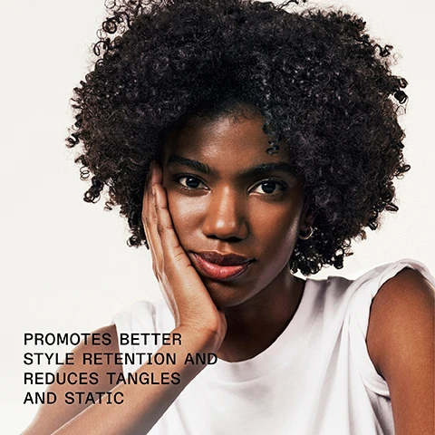 Image 1 - A woman with curly hair rests her hand on her face, looking directly at the camera with a slight smile, with text below her stating PROMOTES BETTER STYLE RETENTION AND REDUCES TANGLES AND STATIC.
Image 2 - A bottle of Olaplex No. 9 Bond Protector Nourishing Hair Serum with text stating 48 Hr POLLUTION PROTECTION and additional details about its antioxidant-rich formula for all hair types.
Image 3 - Image showing two side-by-side views of hair: the left side labeled BEFORE displays dry, frizzy hair, while the right side labeled AFTER shows well-defined, tight curls; at the bottom, text reads UNTREATED IMAGES followed by *Results may vary. Results achieved by cleansing with N°4 Bond Maintenance® Shampoo, conditioning with N°5 Bond Maintenance® Conditioner, and applying N°9 Bond Protector Nourishing Hair Serum to damp hair before styling.
Image 4 - Image comparison showing two sections of hair labeled BEFORE on the left with frizzy, textured hair and AFTER on the right with smooth, shiny hair, with visible text underneath that reads UNTOUCHED IMAGES* *Results may vary. Results achieved by cleansing with Nº4 Bond Maintenance® Shampoo, conditioning with Nº5 Bond Maintenance® Conditioner, and applying Nº9 Bond Protector Nourishing Hair Serum to damp hair before styling.
Image 5 - Image shows two OLAPLEX hair care products: a white bottle labeled Olaplex No. 9 Bond Protector Nourishing Hair Serum and a yellow bottle labeled Olaplex No. 7 Bonding Oil, with text that says Add OLAPLEX N°7 For Even More Shine, Multi-Benefit Styling Serum, and Boost Shine + Softness.