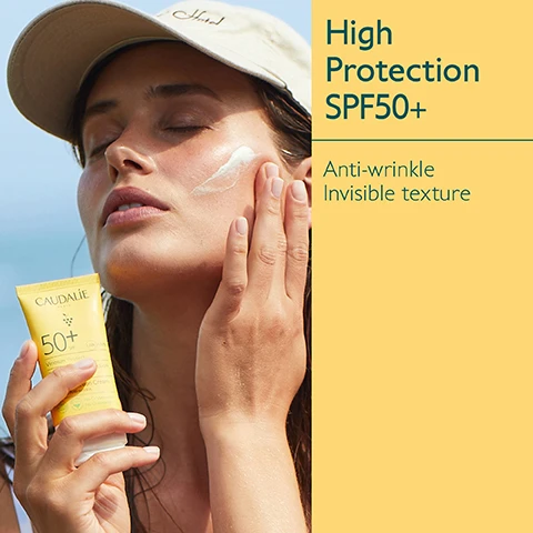 Image 1 - A woman applies sunscreen to her face while holding a tube of Caudalie High Protection SPF 50+, which has visible text that reads High Protection SPF50+ Anti-wrinkle Invisible texture.
Image 2 - A tube of CAUDALIE sunscreen with SPF 50+ is shown beside green grapes and a banana peel, highlighting its ingredients: Grapeseed polyphenols and Vitamin E as antioxidants, with text indicating it offers very high protection.
Image 3 - Image shows a collection of sun protection products from Caudalies Vinosun Protect line, including a spray, cream, sun water, lightweight cream, and stick, all displayed against a yellow background with visible labels indicating their SPF ratings.
Image 4 - Image compares two sunscreen products: a High Protection Cream with a yellow and white tube labeled 50 on the left, and a Very High Protection Lightweight Cream with a yellow tube labeled 50+ on the right, with check marks indicating features such as cream texture, before sun exposure, sweet summer scent for the left product, and fluid texture, daily use, fragrance-free for the right product.
Image 5 - A collection of sun protection products on a sandy surface, featuring yellow packaging with the brand name Caudalie, and text stating Suitable for children from 3 years, UVA/UVB High Protection, and Green on scanner apps.