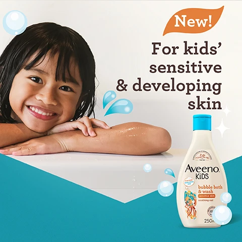 Image 1 - A smiling child with long, dark hair rests their arms on a white surface, next to a bottle of Aveeno Kids bubble bath and wash labeled for kids sensitive and developing skin, with bubbles and a splash graphic in the background. Visible text reads New! For kids sensitive & developing skin.
Image 2 - A bottle of Aveeno Kids bubble bath and wash, featuring a blue lid and a label that includes the text Tear-free, Free from sulphates, soap & dyes, and Gentle fragrance, alongside a pediatrician and dermatologist tested logo.
Image 3 - A clear hexagonal dish containing clusters of dried oat flowers with the text Enriched with soothing oat above.
Image 4 - A bottle of Aveeno Kids bubble bath and wash, featuring an octopus character, is shown against a turquoise background with bubbles alongside the text that reads Gently washes away dirt, whilst nourishing skin.
Image 5 - A bottle of Aveeno Kids bubble bath and wash is shown against a teal background, featuring a character made of colorful shapes and the text Recyclable Bottle and 50% Recycled Plastic bottle.
Image 6 - Image shows three Aveeno Kids product bottles labeled bubble bath and wash, shampoo, and conditioner, positioned on a light background with playful elements; visible text includes Proven to cleanse, protect & help nourish kids’ developing skin, scalp and hair.