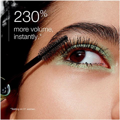 Image 1 - Close-up of an eye with thick, voluminous eyelashes and green eyeshadow, featuring text that reads 230% more volume, instantly, and a note stating Testing on 31 women.
Image 2 - Image shows a close-up of a brown eye, with the top half labeled Before showing natural eyelashes, and the bottom half labeled After application displaying longer, more defined eyelashes.
Image 3 - An image of a mascara brush against a backdrop of black mascara swirls with text that reads High-Def Wave Brush coats + combs every lash and Precision tip defines corner lashes.