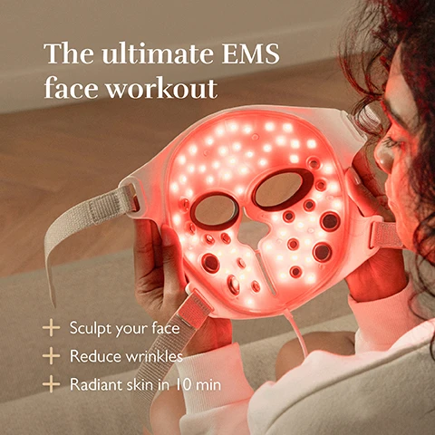 Image 1 - A person holds a glowing red facial device with holes for the eyes, surrounded by text that reads The ultimate EMS face workout and three bullet points stating Sculpt your face, Reduce wrinkles, and Radiant skin in 10 min.
Image 2 - A persons hand is holding a facial mask with embedded devices, accompanied by text that reads Feel the lifting effect Deep lift & define facial contours with Electrical Muscle Stimulation.
Image 3 - A woman with curly hair wears a white sweater while holding a white skincare device resembling a mask, with red light illuminating the scene; visible text reads AI-guided skincare insight See your future self with our smart Silkn AI-simulator.
Image 4 - A person with curly hair wearing a white LED facial mask is seated and holding a handheld device, with text on the image stating Boost collagen, smooth fine lines, Deep Near-Infrared, LED light between 463-1072nm, and 40K light pulses per second.