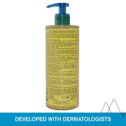 Image 1 - A transparent container of liquid soap with a blue pump top, featuring extensive text on the back in multiple languages and a bold label at the bottom that reads DEVELOPED WITH DERMATOLOGISTS.
Image 2 - A close-up image shows a persons arm with a foaming gel-in-oil cleanser being lathered with hands, accompanied by text that reads ALL SKIN TYPES - EVEN SENSITIVE, Foaming gel-in-oil cleanser, Soap-free, and Delightful fragrance.
Image 3 - A clear bottle of Uriage cleansing oil labeled with CLEANSER WITH 25% GLYCERIN and information stating it LEAVES A SOFT PROTECTIVE FILM and PROTECTS SKIN FROM THE DRYING EFFECTS OF WATER.
Image 4 - A scenic view of snowy mountains under a blue sky with text that states Dermatologically and ophthalmologically tested, Suitable for sensitive skin, Physiological pH (5,5), and Soap-free.
Image 5 - A transparent pump bottle of Uriage Cleansing Oil, labeled in both French and English, displaying the text Huile Lavante, Nettoie, Nourrit, Préserve du dessèchement, Cleansing Oil, Cleanses, Nourishes, Prevents dryness and Peaux Sensibles, Sensitive Skin with a blue pump top and a light yellow hue.